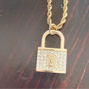 LV Vintage EUC Gold Tone stamped
Lock on 18" 18kt over titanium
rope chain